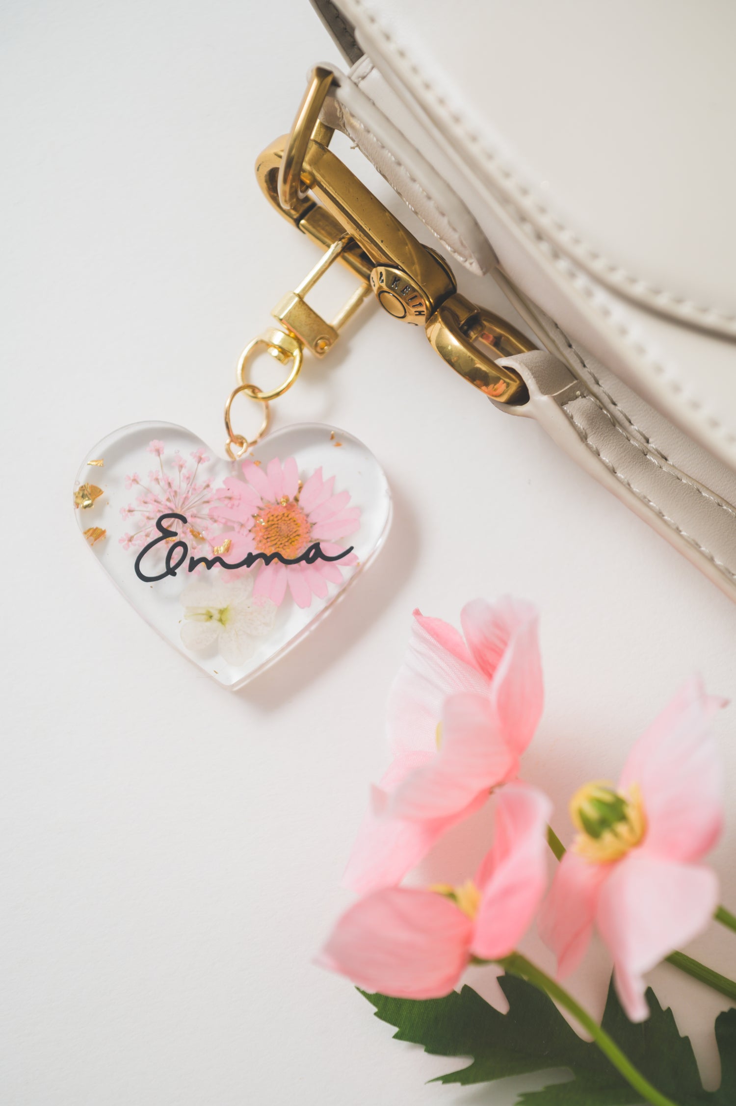 Handmade heart-shaped resin keychain with customizable name 'Emma'